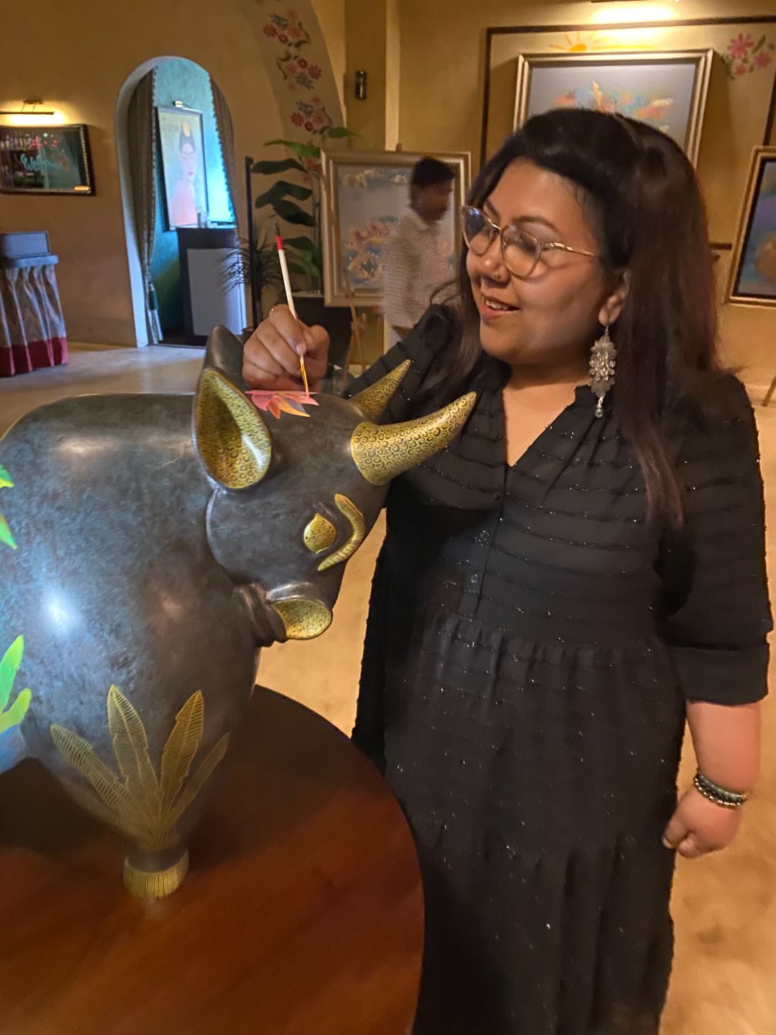 Shampa Sircar Das painting a lotus on the bronze bull