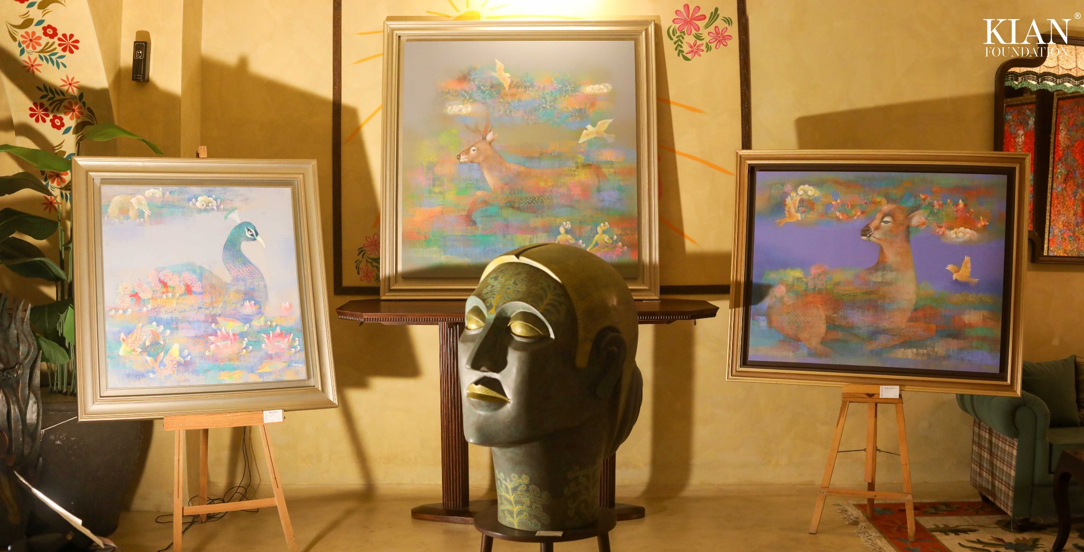 Peacock, deer and bronze head installation